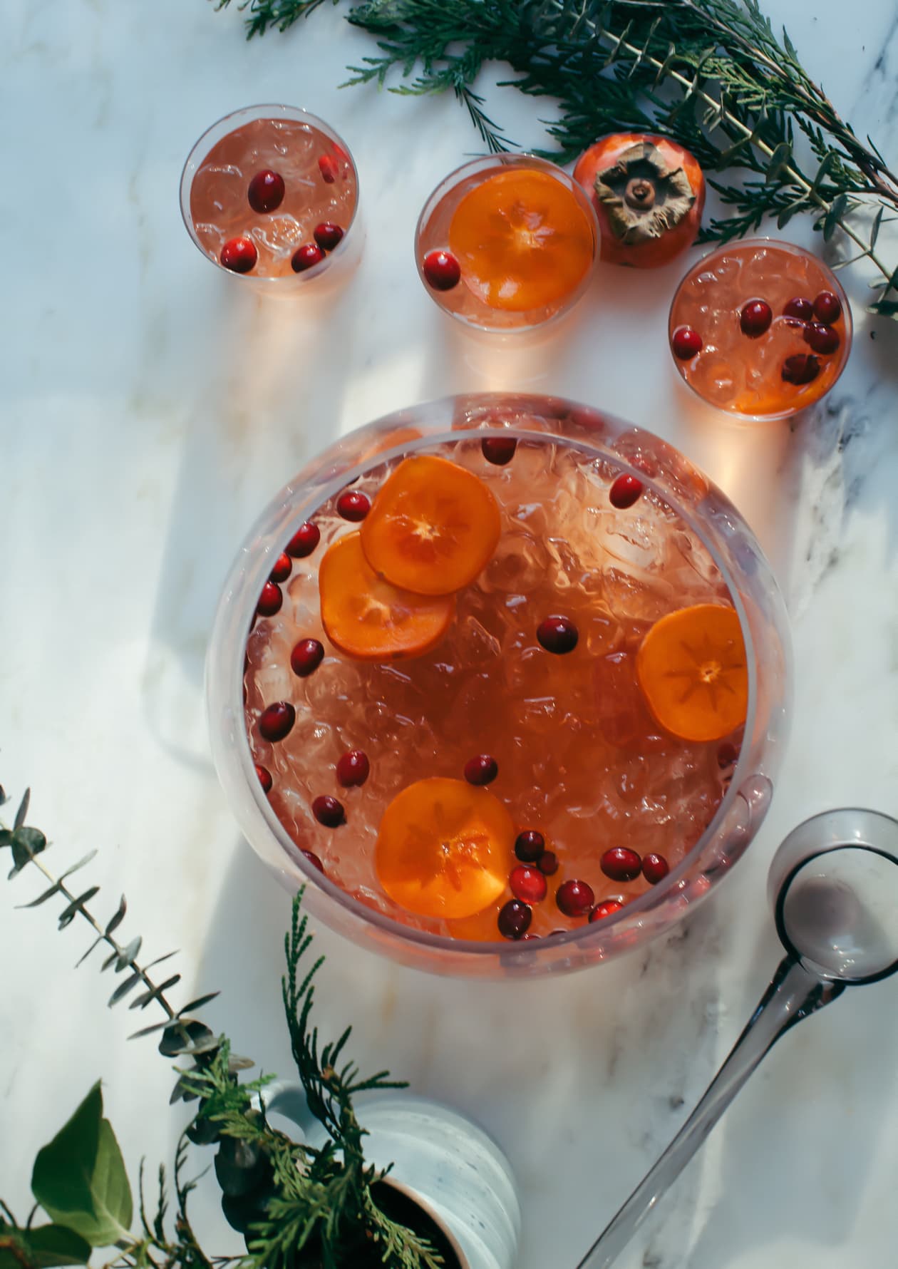 Glasses with Sparkling Rosé Punch with Cranberry and Persimmon