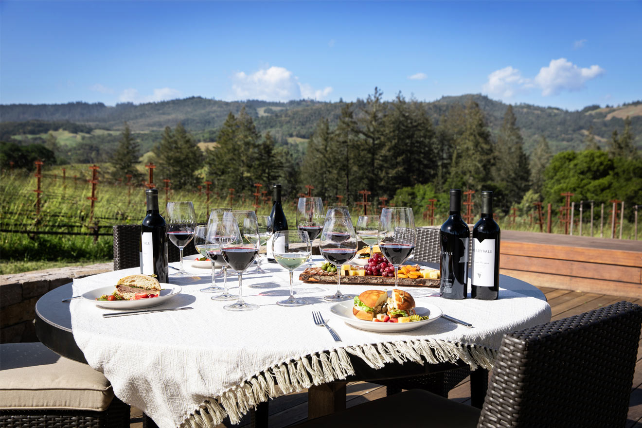 outdoor dining table setup with wine and food